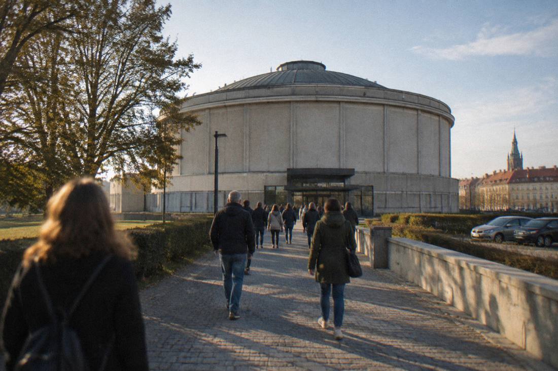 Visitors walking toward the domed rotunda of the Panorama Raclawicka in Wroclaw