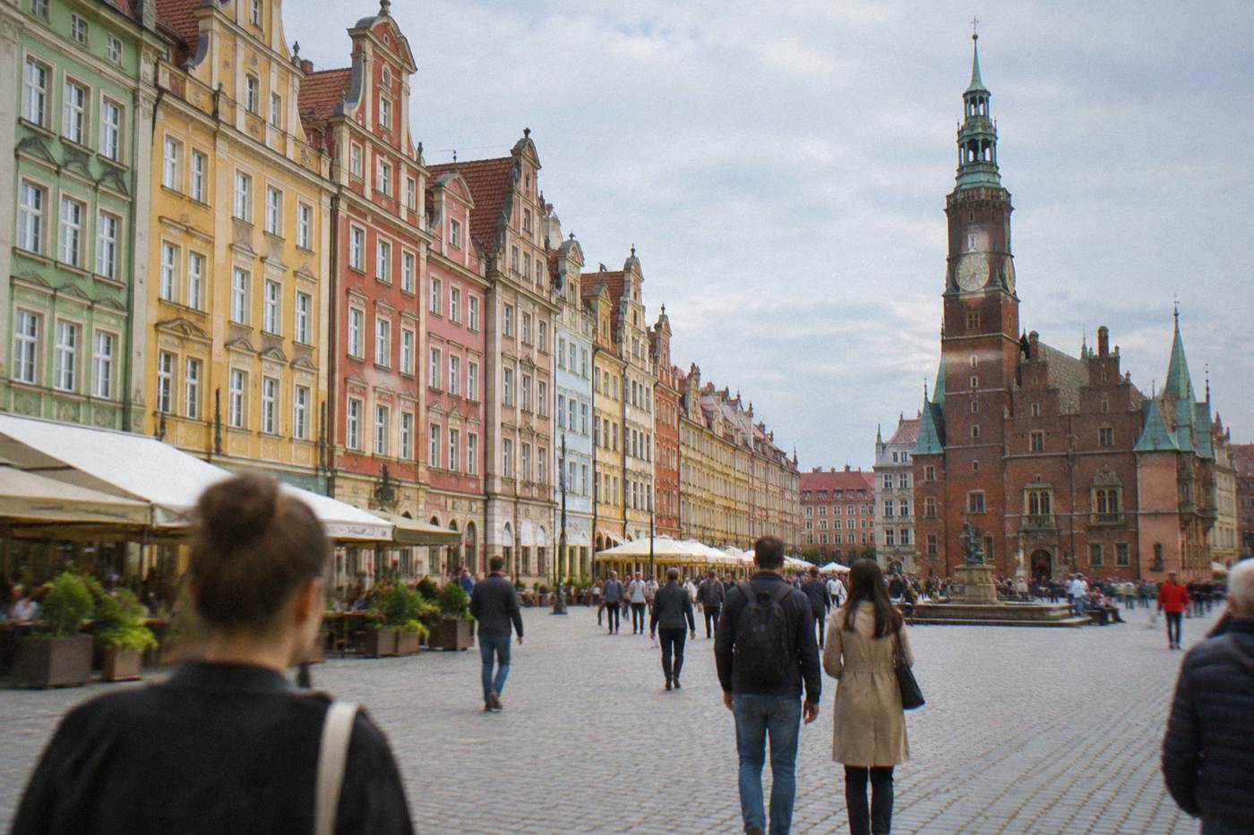 Colorful burgher houses lining Wroclaw's large market square on a bright day