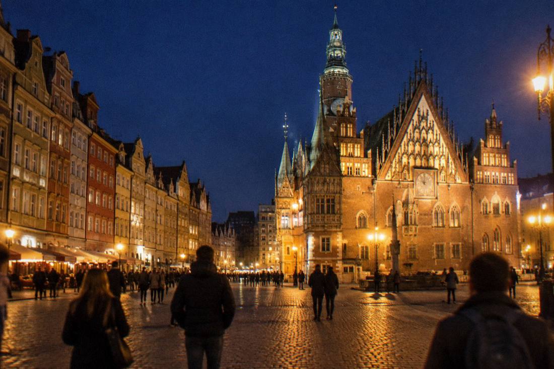 Illuminated Gothic town hall and townhouses on Wroclaw Market Square at night