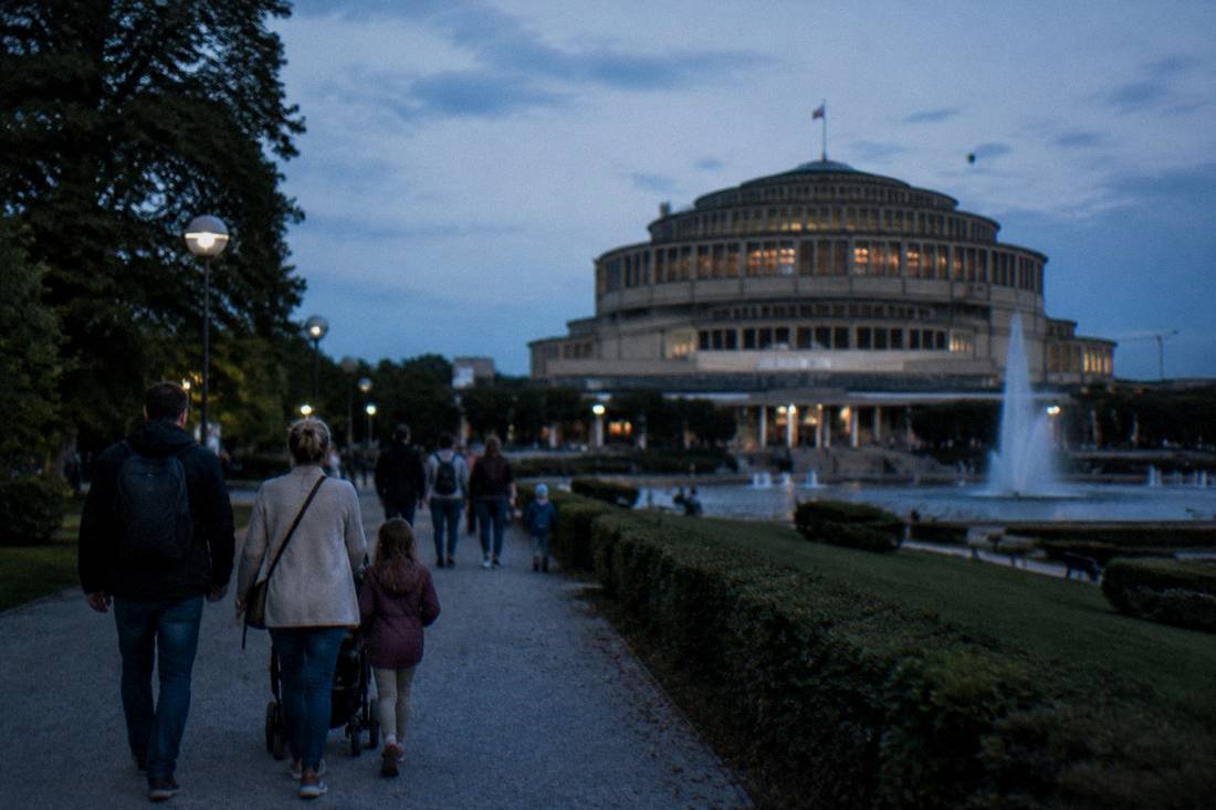 Families walking through the park around Centennial Hall in Wroclaw