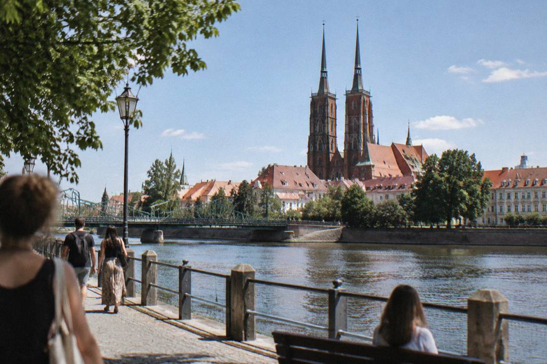 The twin spires of the cathedral on Ostrow Tumski seen across the Odra river in summer
