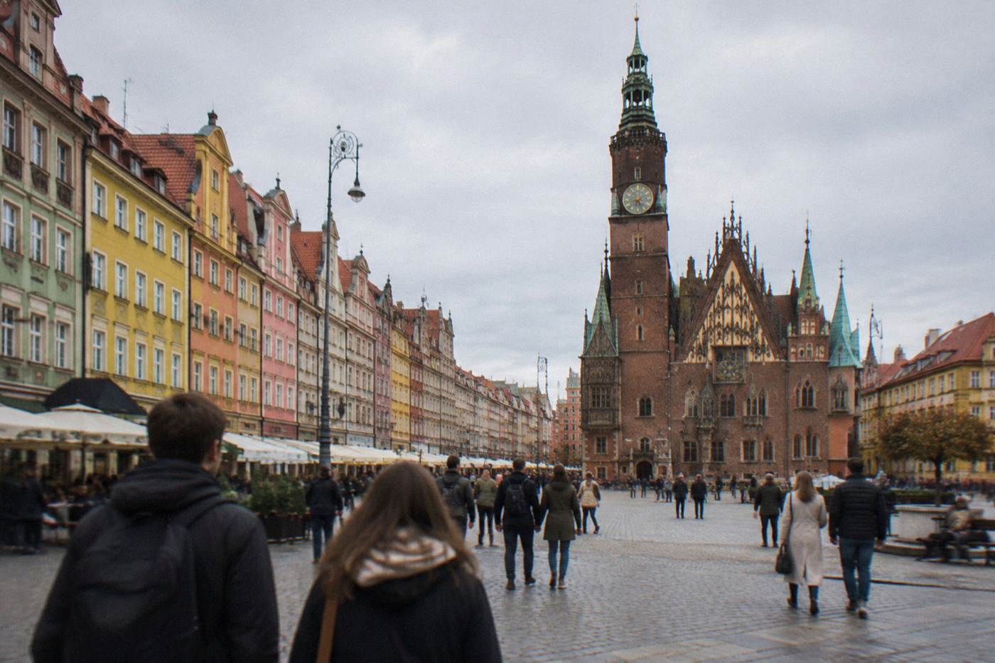 Wide view of Wroclaw Market Square with colorful townhouses and the Gothic town hall