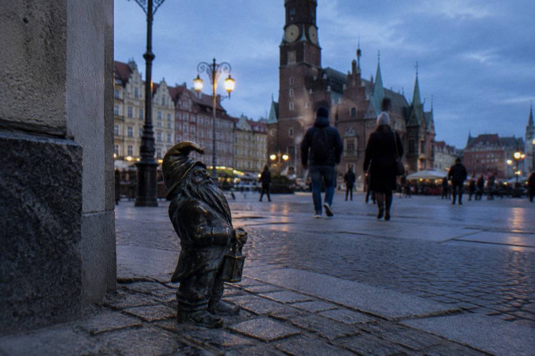 Small bronze dwarf statue on a Wroclaw street corner near the Market Square