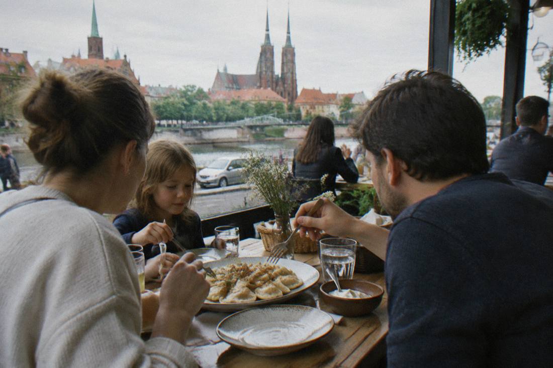 A family sharing a plate of pierogi at a wooden table in a Wroclaw restaurant