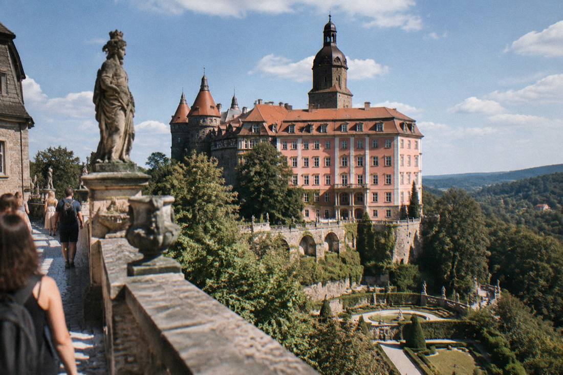 The terraces and towers of Ksiaz Castle above its gardens on a summer day